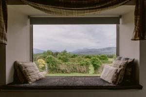 a large window with a view of a field at Dunruadh Cottage in Gartocharn
