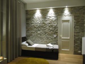 ローマにあるCasa Vacanze Pietro al Vaticanoのレンガの壁、ベッド付きのベッドルーム1室