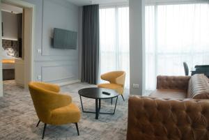 ein Wohnzimmer mit einem Sofa, Stühlen und einem Tisch in der Unterkunft H41 Luxury Suites in Belgrad