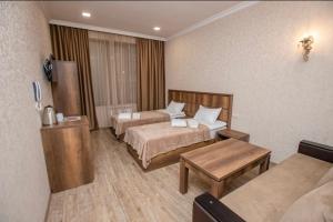 Voodi või voodid majutusasutuse Palermo Hotel toas