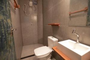un bagno con wc, lavandino e doccia di Apartamentos Prana a Itacaré