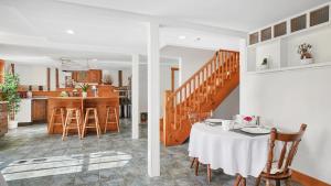 a dining room and kitchen with a table and chairs at Sail Inn Lunenburg in Lunenburg