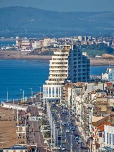 a view of a city with buildings and the ocean at Sea La Vie apartment in Hastings