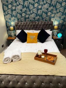 a bedroom with a bed with a tray of food on it at Sea La Vie apartment in Hastings