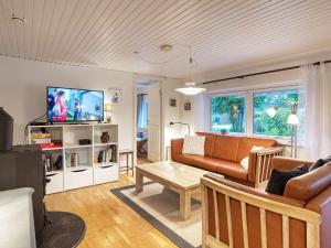 a living room with a couch and a tv at 6 person holiday home in Dannemare in Nakskov