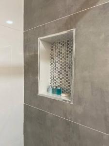 a bathroom with a small window in the wall at Stunning Deluxe Studio in Hialeah