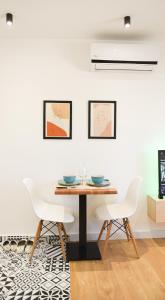 a dining room with a table and two chairs at Matisse No9 - One Bedroom City Center Apartment With Parking in Tirana +22 photos