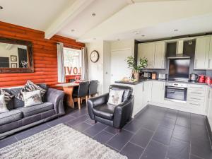 a living room with two couches and a table at The Red in St Asaph