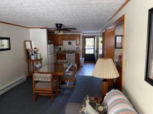 a kitchen and dining room with a table and a couch at 2 Bedroom 2 Bathroom - Blue Knob All Season Resort Condo in Claysburg