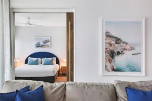 a hotel room with a bed and a large window at Element on Coolum Beach in Coolum Beach