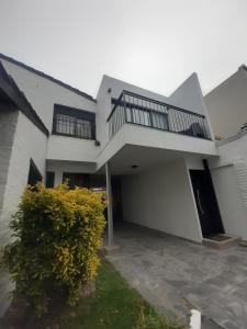a large white house with a staircase on it at PH playa Grande in Mar del Plata