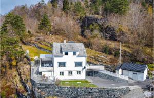 an aerial view of a white house on a hill at Amazing Home In Strandebarm With House Sea View in Strandebarm