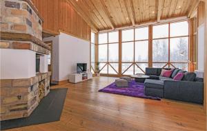 a living room with a couch and a fireplace at Nice Home In Jrvs With Sauna in Järvsö