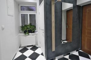 a hallway with a door and a window and a checkered floor at Lux Apartments Prestige in Vienna