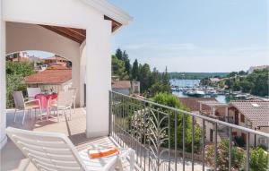 einen Balkon mit Stühlen, einem Tisch und Aussicht in der Unterkunft Beautiful Home In Milna With House Sea View in Milna