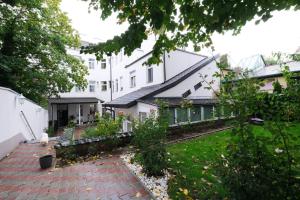 a house with a brick walkway in front of a yard at Lux Apartments Prestige in Vienna