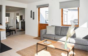 a living room with a couch and a table at Lovely Home In Höör With Wifi in Höör
