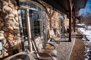 a group of chairs sitting outside of a building at Renovated Chalet at Mystic Springs, Mountain Views, Pets Welcome! in Canmore