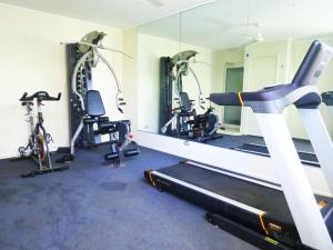 a gym with several tread machines and a mirror at 3 Bedroom Central Beachside Kingscliff Apartment with Pool in Kingscliff