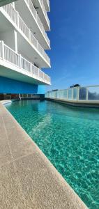 a swimming pool in front of a building at Alquiler Apto Ibiza Playa Corona- Reserva mínimo 2 noches in Copecito