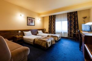 Postel nebo postele na pokoji v ubytování Hotel Marysin Dwór