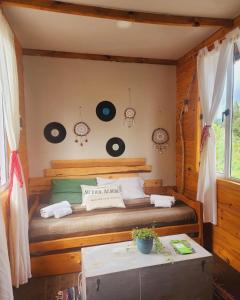 a bedroom with a bed with records on the wall at Santuario Patagonia in El Bolsón