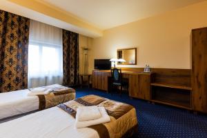 Postel nebo postele na pokoji v ubytování Hotel Marysin Dwór