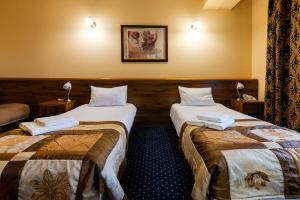 Postel nebo postele na pokoji v ubytování Hotel Marysin Dwór