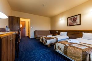Postel nebo postele na pokoji v ubytování Hotel Marysin Dwór
