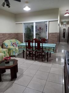 a living room with a ping pong table and chairs at Maranata Casa com Piscina - 2 minutos de carro até o mar in Peruíbe