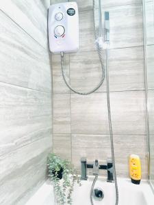 a shower in a bathroom with a bath tub at Ashton house in Killingbeck