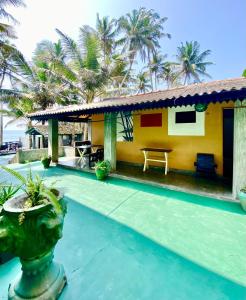 a house with a swimming pool and a resort at Praneeth Guest House in Mirissa