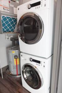 a washer and dryer stacked on top of each other at Luxury Downtown Apartment with Balcony! in Greenville
