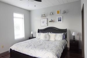a white bedroom with a large bed with pillows at Luxury Downtown Apartment with Balcony! in Greenville