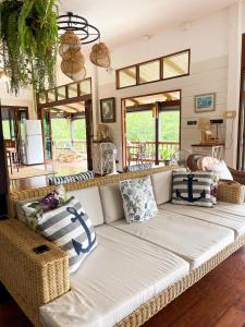 a living room with a white couch and some windows at À La Koh Kood Resort in Ko Kood