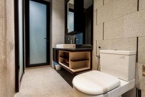 a bathroom with a toilet and a sink at Scarletz Suites KLCC by Mana-Mana in Kuala Lumpur