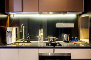 a kitchen with a sink and a counter top at Scarletz Suites KLCC by Mana-Mana in Kuala Lumpur