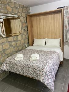 a bedroom with a bed with two phones on it at Patriko in Kalabaka