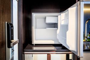 an empty refrigerator with its door open in a kitchen at Scarletz Suites KLCC by Mana-Mana in Kuala Lumpur