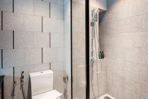a bathroom with a shower and a toilet in it at Scarletz Suites KLCC by Mana-Mana in Kuala Lumpur