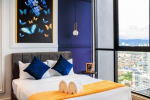 a bedroom with a bed with blue walls and a window at Scarletz Suites KLCC by Mana-Mana in Kuala Lumpur