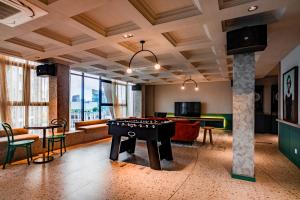 a living room with a pool table and a game room at Scarletz Suites KLCC by Mana-Mana in Kuala Lumpur