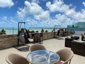 a patio with chairs and tables and a playground at Bela Hospedagem - Imperial Flat - Beira mar de Tambaú in João Pessoa