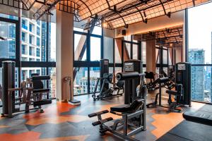 a gym with treadmills and cardio equipment in a building at Scarletz Suites KLCC by Mana-Mana in Kuala Lumpur