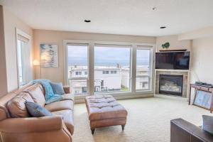 a living room with a couch and a fireplace at Rockaway oceanview condo,Steps to the beach & Downtown,W&D, WiFi in Rockaway Beach