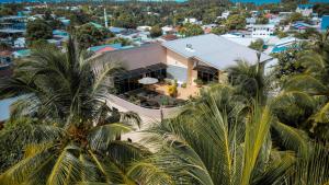 an aerial view of a house with palm trees at Blue Wave Hotel Maldives for SURF, FISHING and Beach in Kudahuvadhoo