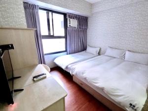 Postel nebo postele na pokoji v ubytování Feng Chia Hygge