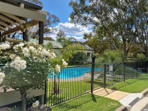 a fence in front of a swimming pool at Golden Heritage Accommodation in Beechworth