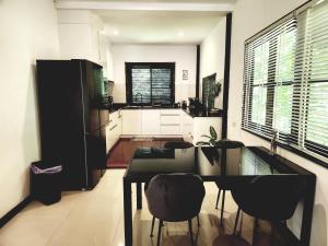 a kitchen with a table and chairs in a room at Genesis villa- front beach peaceful villa big infinity swimming pool in Amphoe Koh Samui