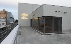 a building with glass doors on the side of it at Hotel Mazarium in Morioka